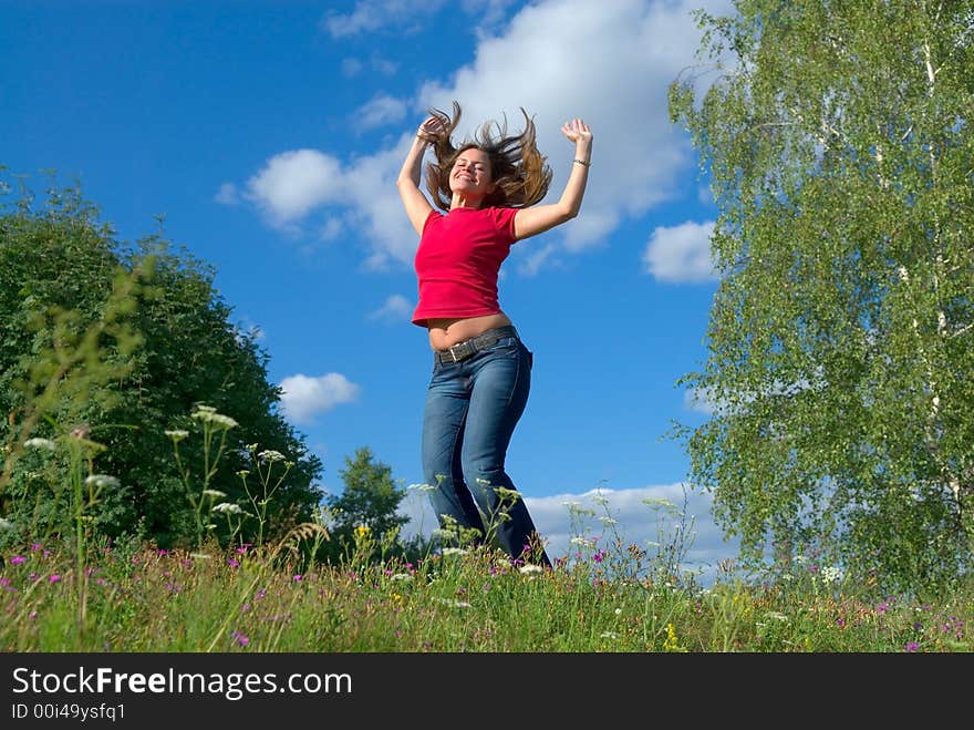 Beautiful lady jumping in summer landscape. Beautiful lady jumping in summer landscape