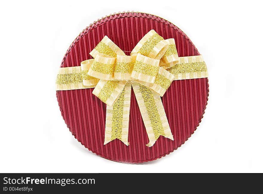 Red present box with gold ribbon on white background