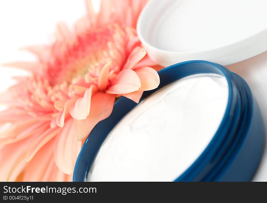 Face cream with flower isolated on white background