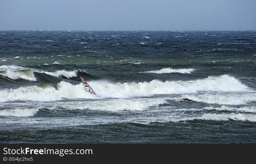 Windsurfer Fighting With Waves