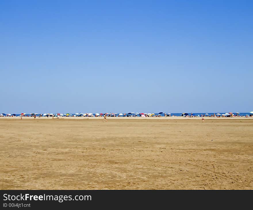 Line of colored sunshades on the beach. Line of colored sunshades on the beach