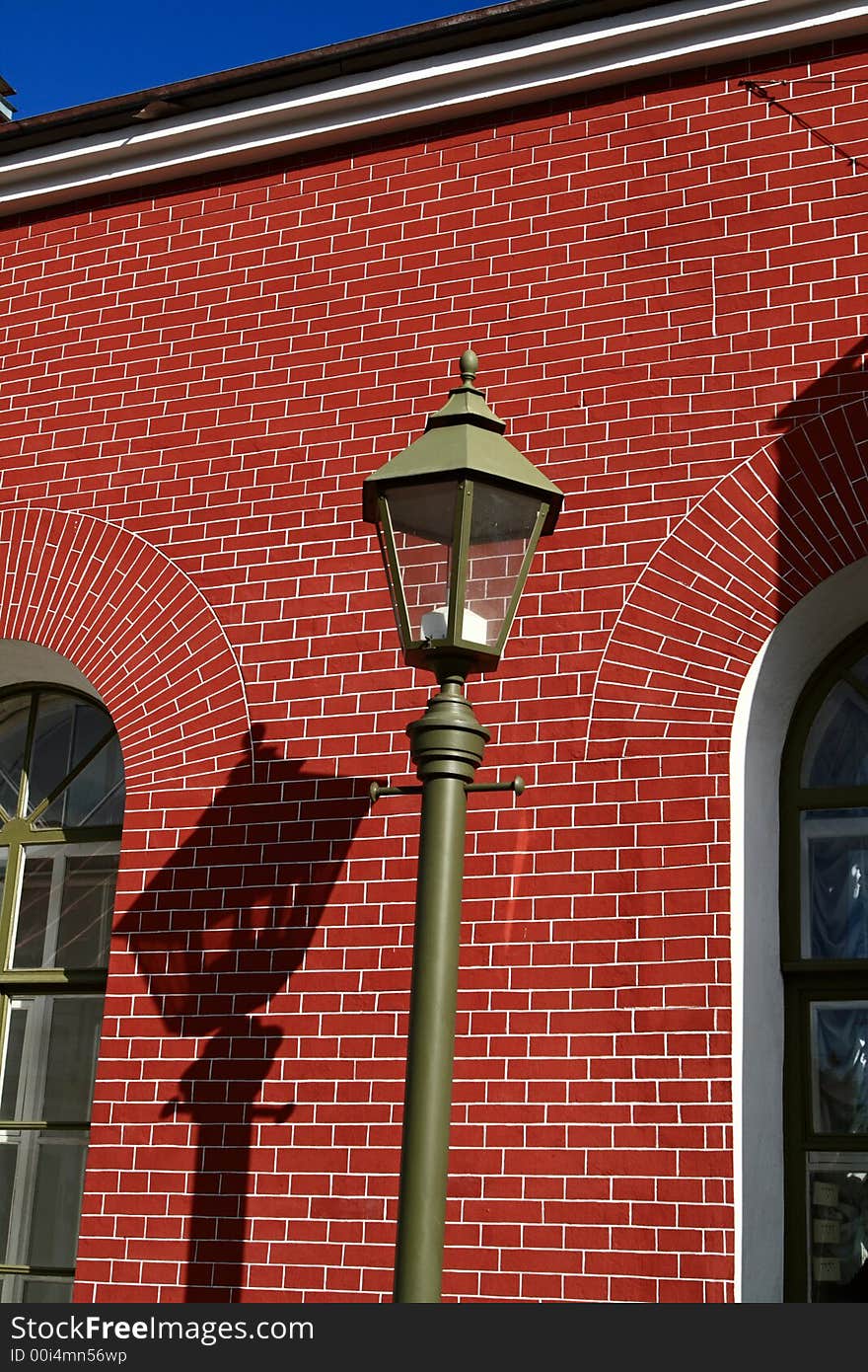 Street lamp on the red wall background