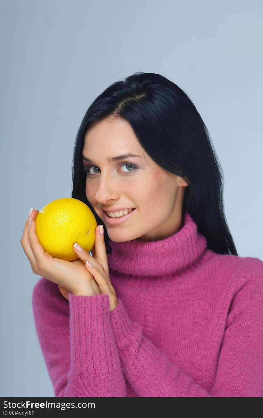 Portrait of woman with grapefruit