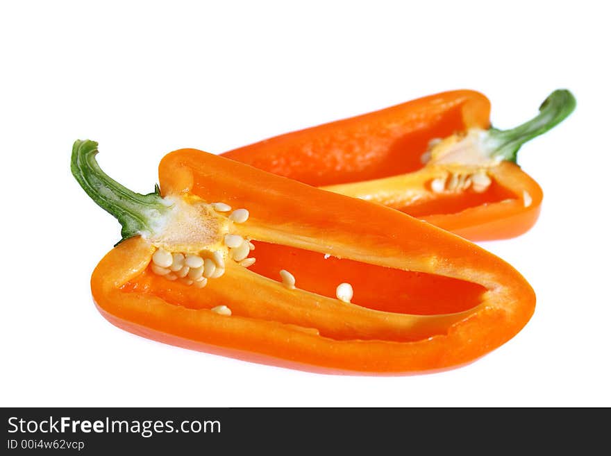 Two half of sliced orange bell pointed pepper, close-up, soft focus, white background, no shadow. Two half of sliced orange bell pointed pepper, close-up, soft focus, white background, no shadow