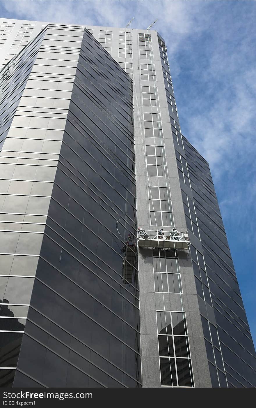 Skyscrapers towering over Calgary Alberta Canada with window cleaners. Skyscrapers towering over Calgary Alberta Canada with window cleaners.