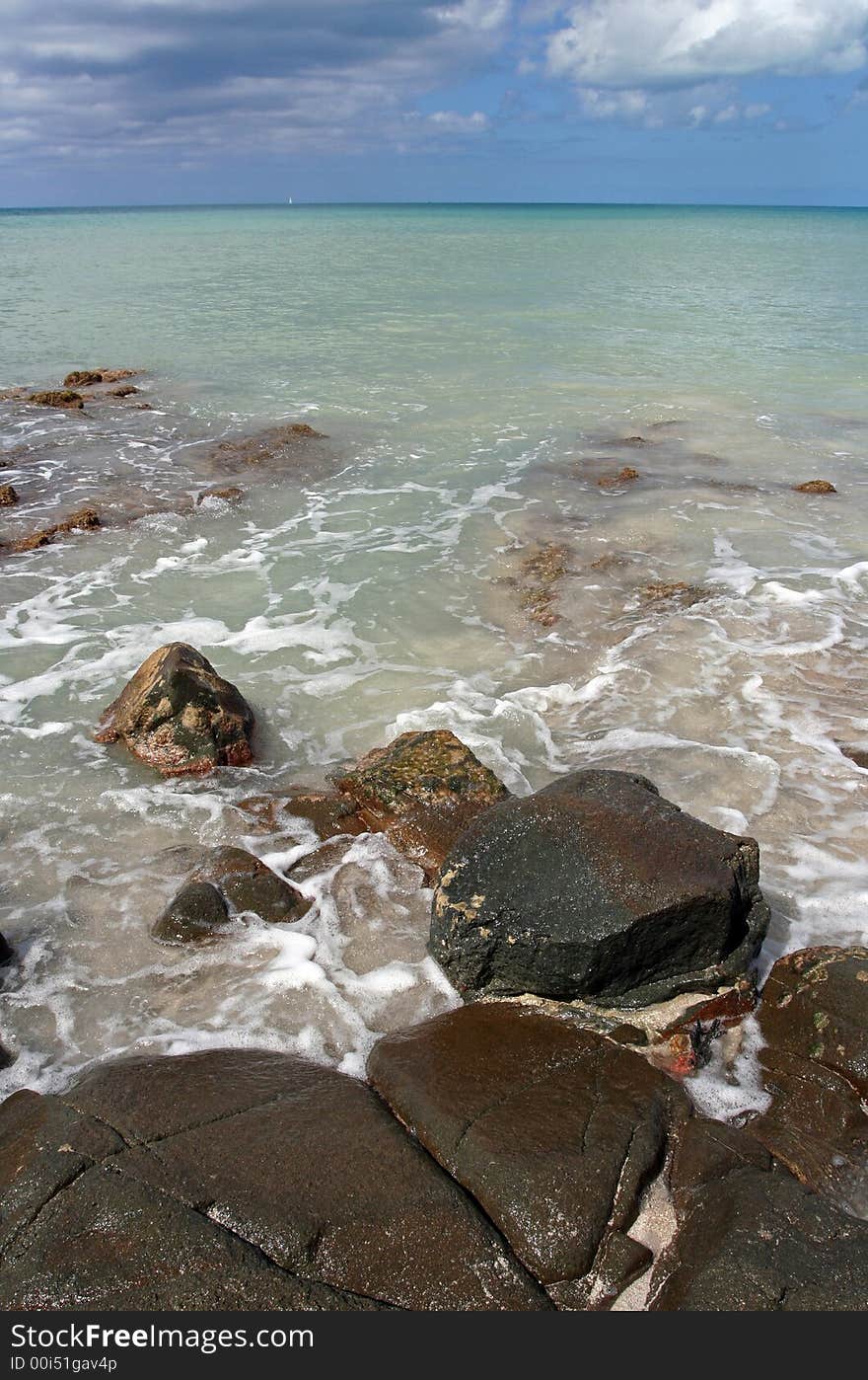 Beautiful Caribbean beach shore with large rocks and clear turquoise water. Beautiful Caribbean beach shore with large rocks and clear turquoise water.