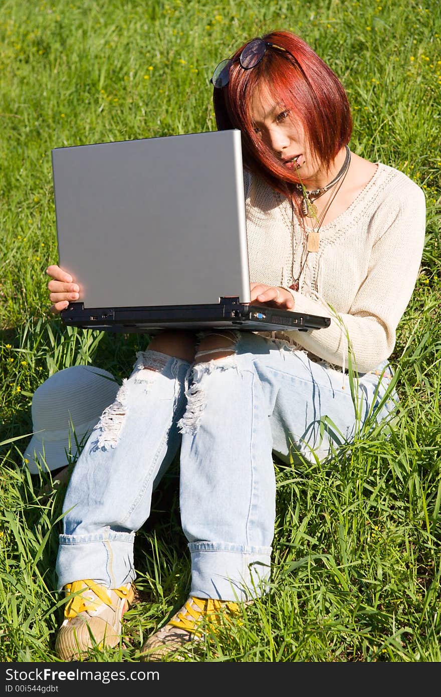 Teenager relaxing outdoors with notebook. Teenager relaxing outdoors with notebook