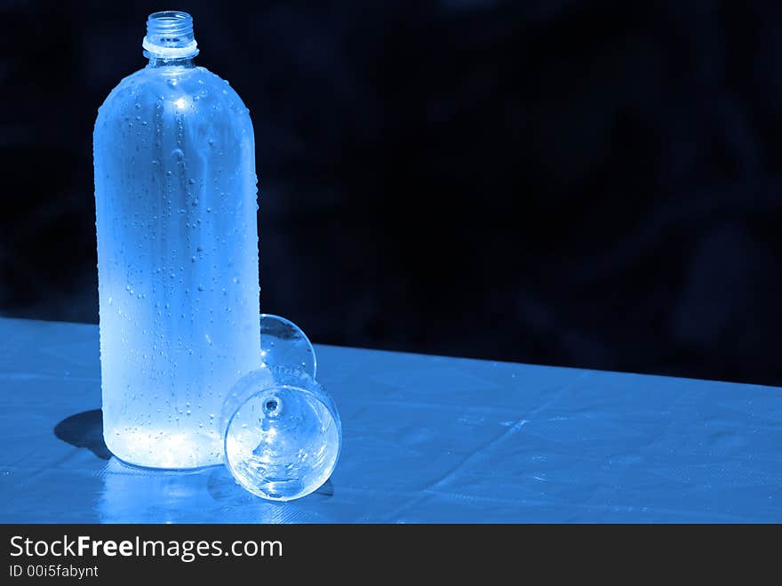 Bottle with glass and tablecloth. Bottle with glass and tablecloth