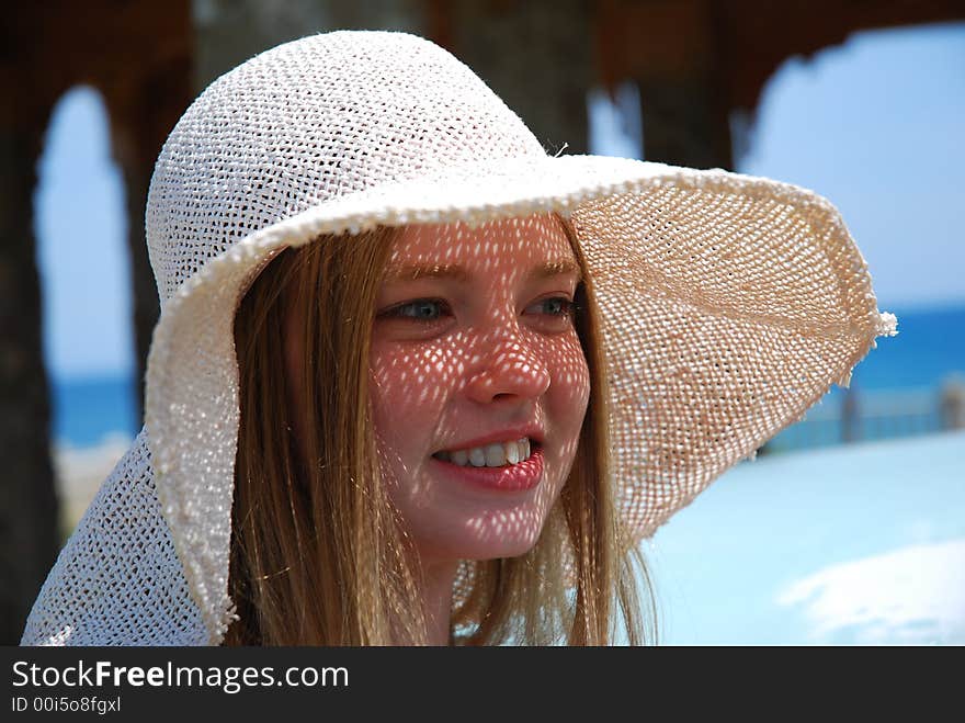 Smile blonde call girl in white hat. Smile blonde call girl in white hat