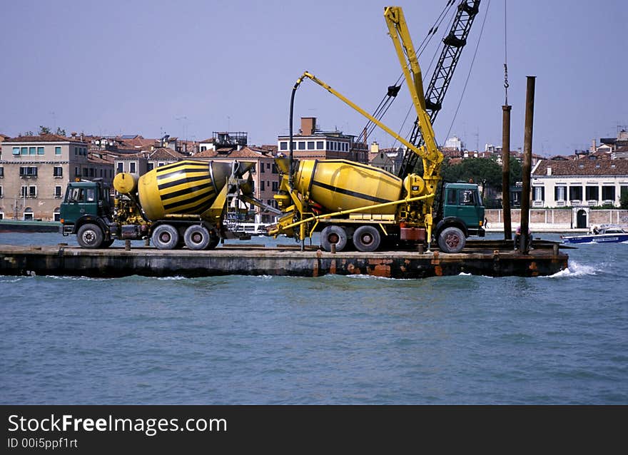 Two cement mixers on a barge arriving in Venice. Two cement mixers on a barge arriving in Venice.