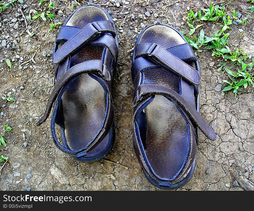 A pair of sandals belong to a tourist enjoying his holidays time. A pair of sandals belong to a tourist enjoying his holidays time