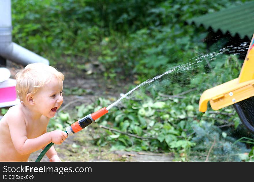 Young boy is playing in the garden