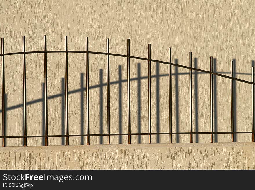 Curved Metal Fence In Morning Sunlight, Shadow, Background