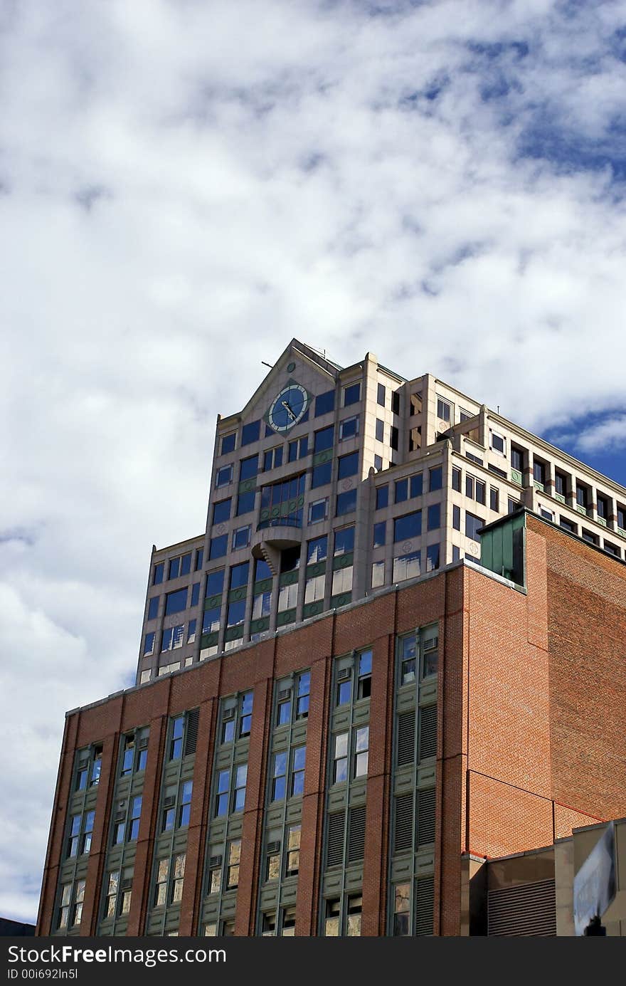 Old boston skyscraper surrounded by clouds and a deep blue sky. Old boston skyscraper surrounded by clouds and a deep blue sky