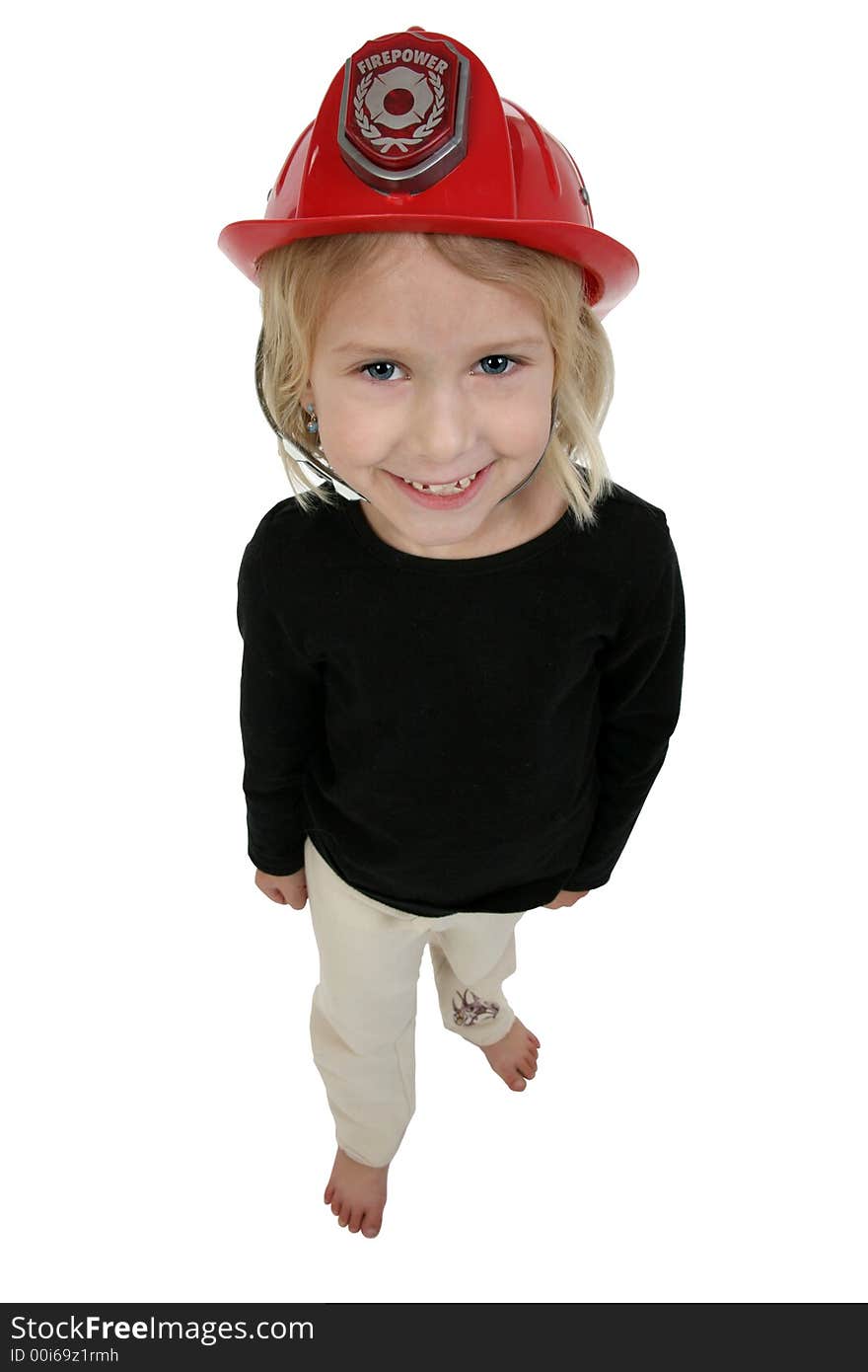 Beautiful six year old girl in toy dress up fire hat