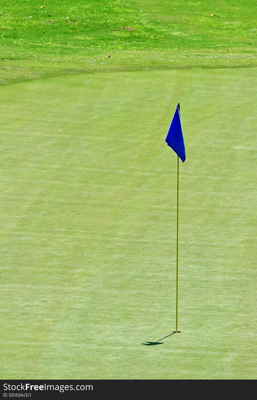 Blue flag on the 18th hole of a golf course