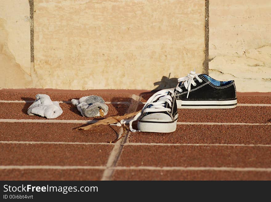 Color photo child sneakers on brick ground.