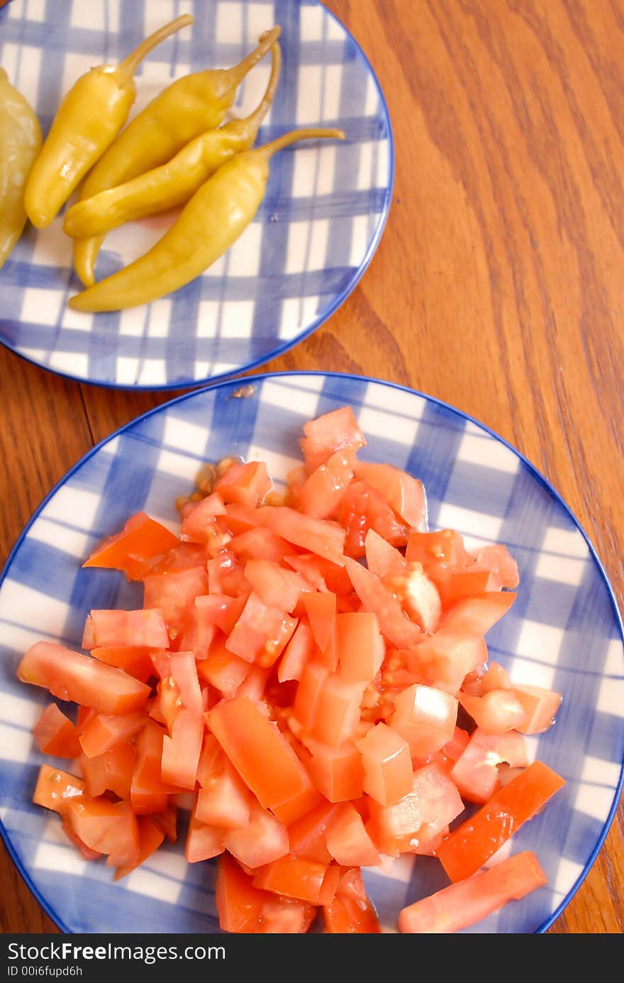 Plates with components for preparation of dishes, Chile pepper and tomato. Plates with components for preparation of dishes, Chile pepper and tomato