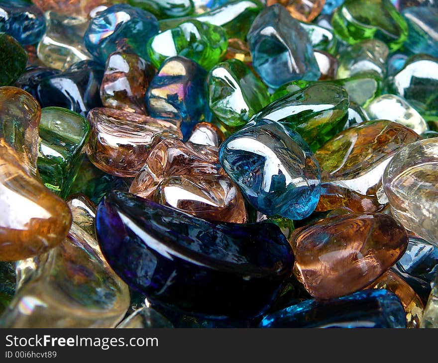 A bin of glass heart, star and moon shapes in various colors.  Foreground contains 3 moon shapes. A bin of glass heart, star and moon shapes in various colors.  Foreground contains 3 moon shapes.