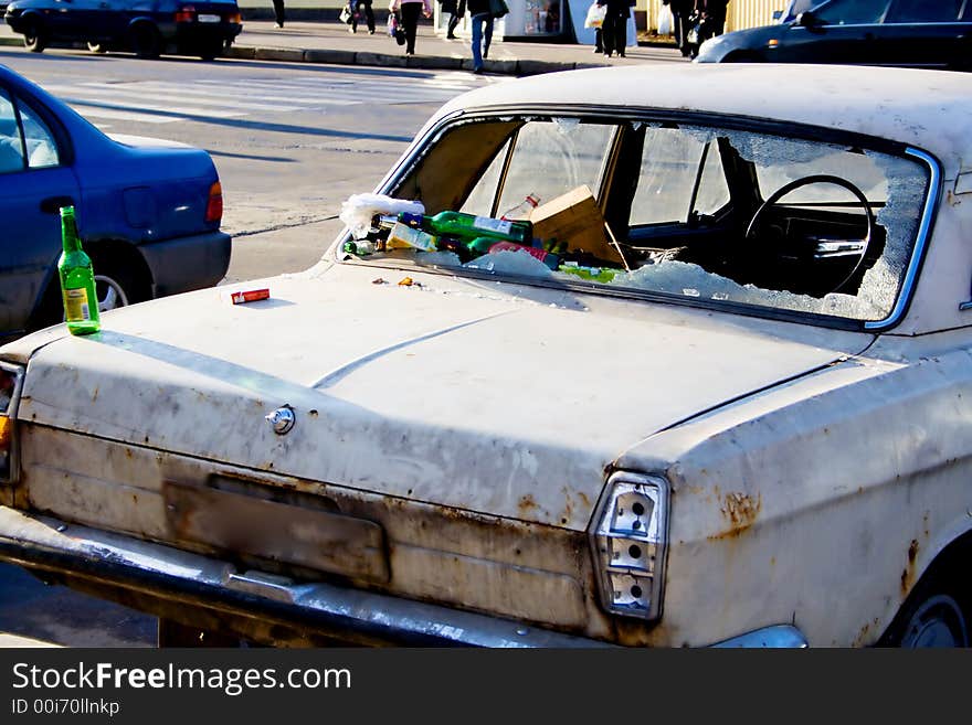 Dump of waste products in the broken thrown car. Dump of waste products in the broken thrown car