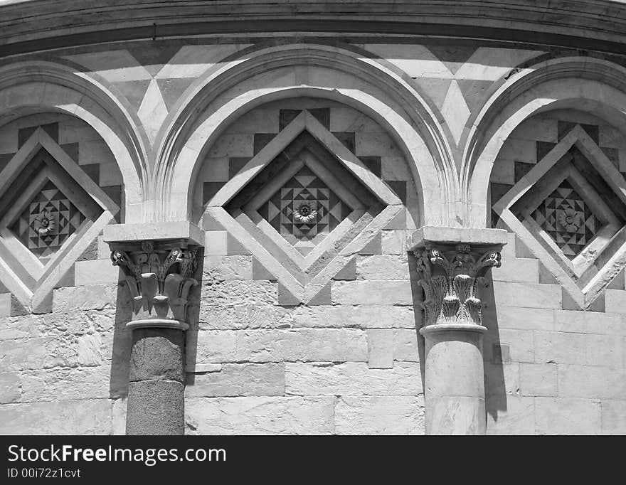 Photograph of the detail of a Romanesque style arched carving on the leaning Tower of Pisa. Photograph of the detail of a Romanesque style arched carving on the leaning Tower of Pisa