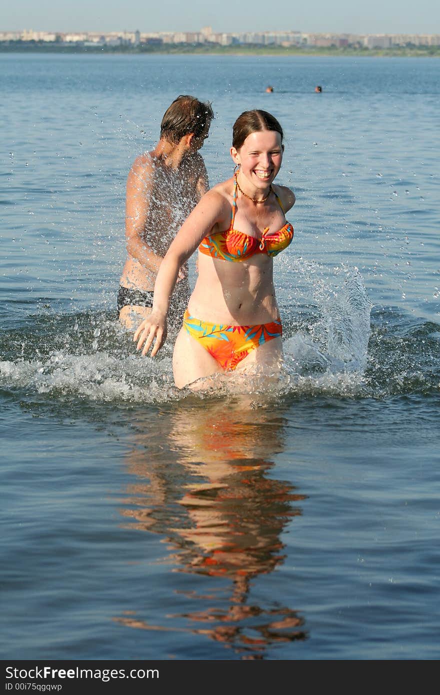 Healthy lifestyle: couple having fun in water