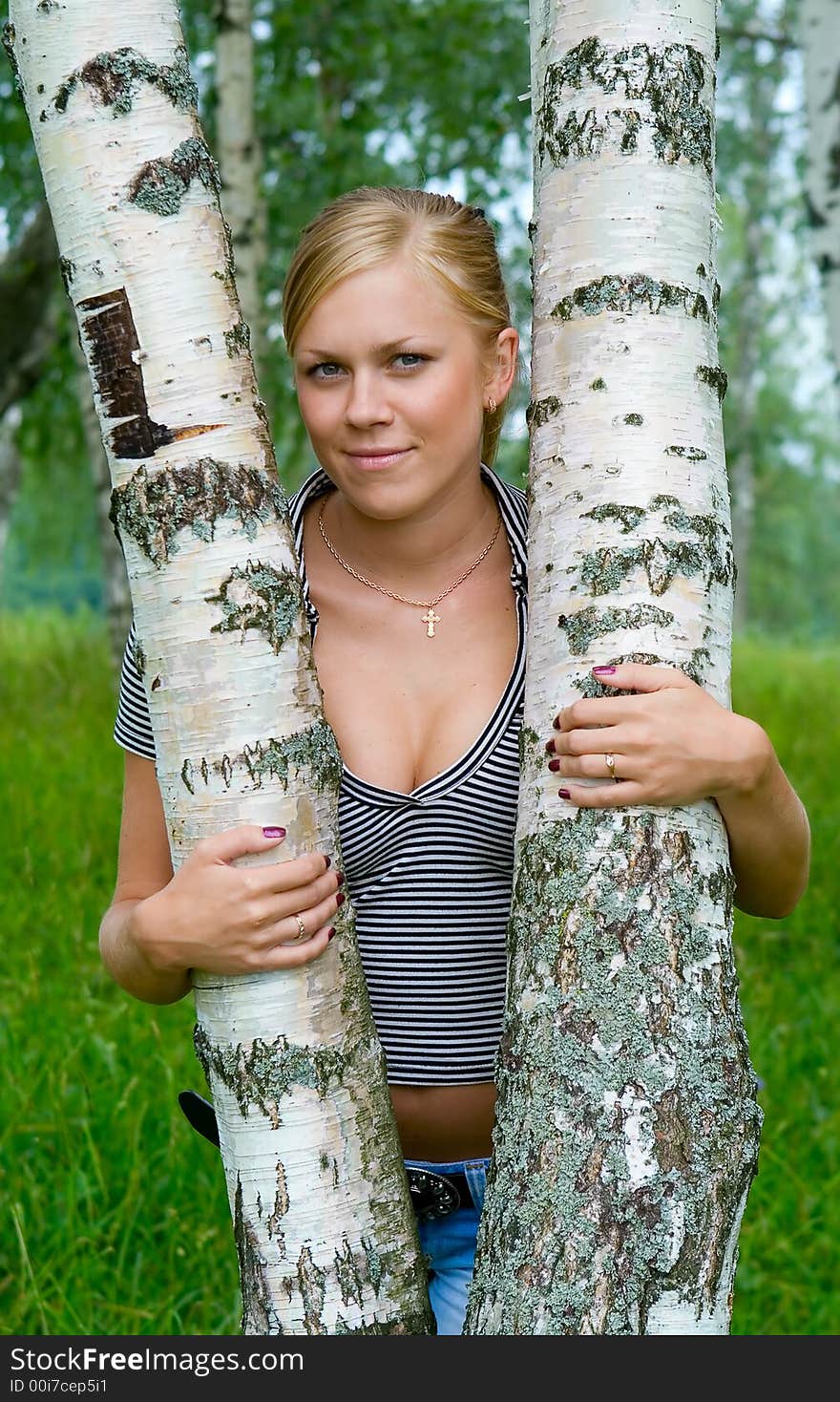 Girl about birches in the summer