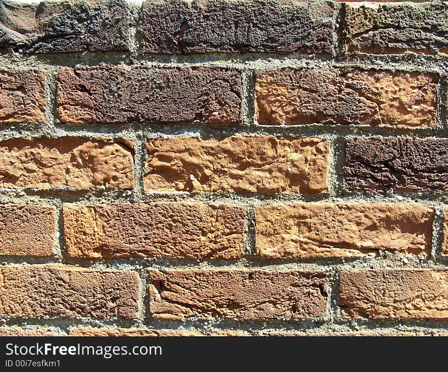 A close up photograph of a brick wall. A close up photograph of a brick wall.