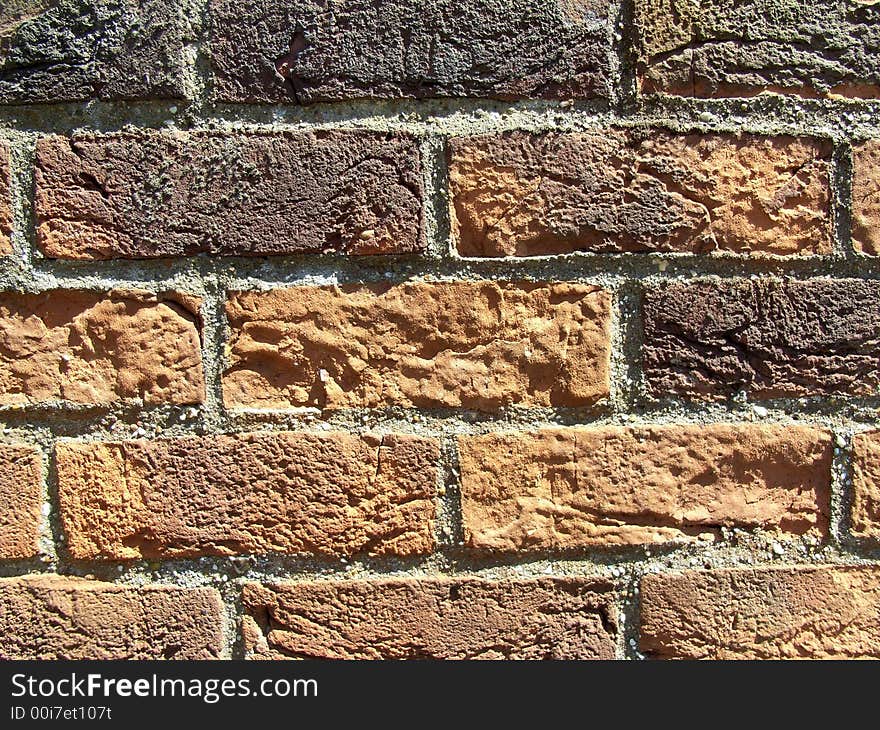 A close up photograph of a brick wall. A close up photograph of a brick wall.