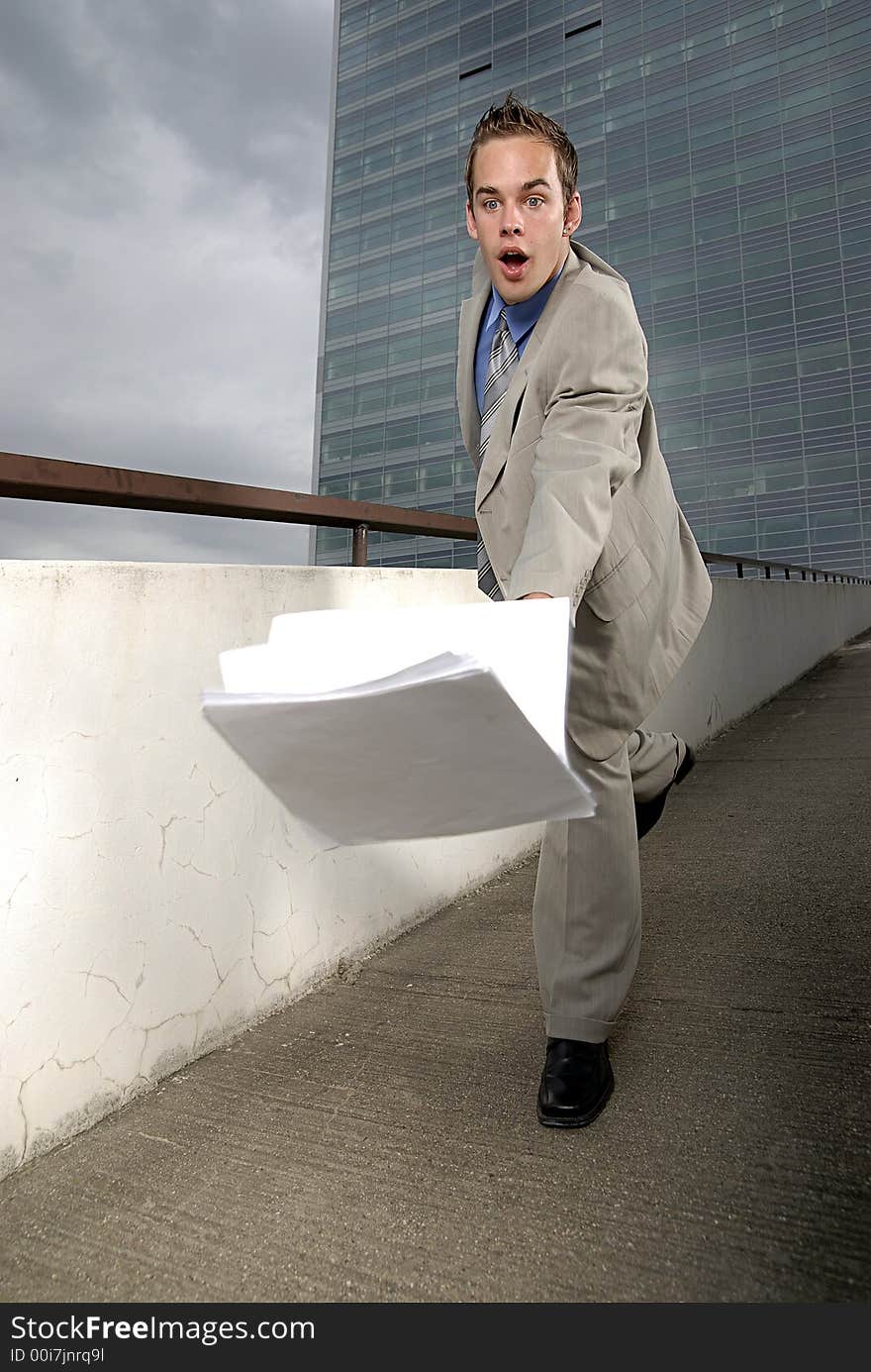 Bad day - fumbler businessman with mobile phone in front of modern business building. Bad day - fumbler businessman with mobile phone in front of modern business building.