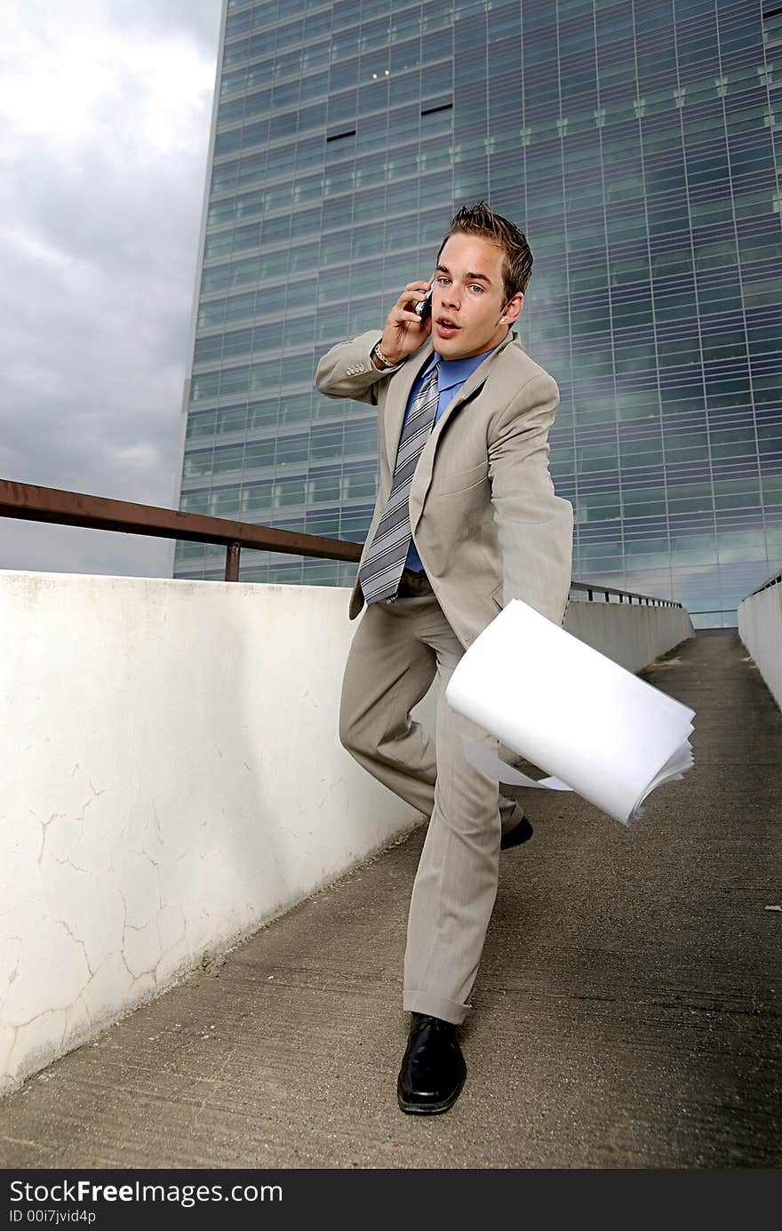 Bad day - fumbler businessman with mobile phone in front of modern business building. Bad day - fumbler businessman with mobile phone in front of modern business building.