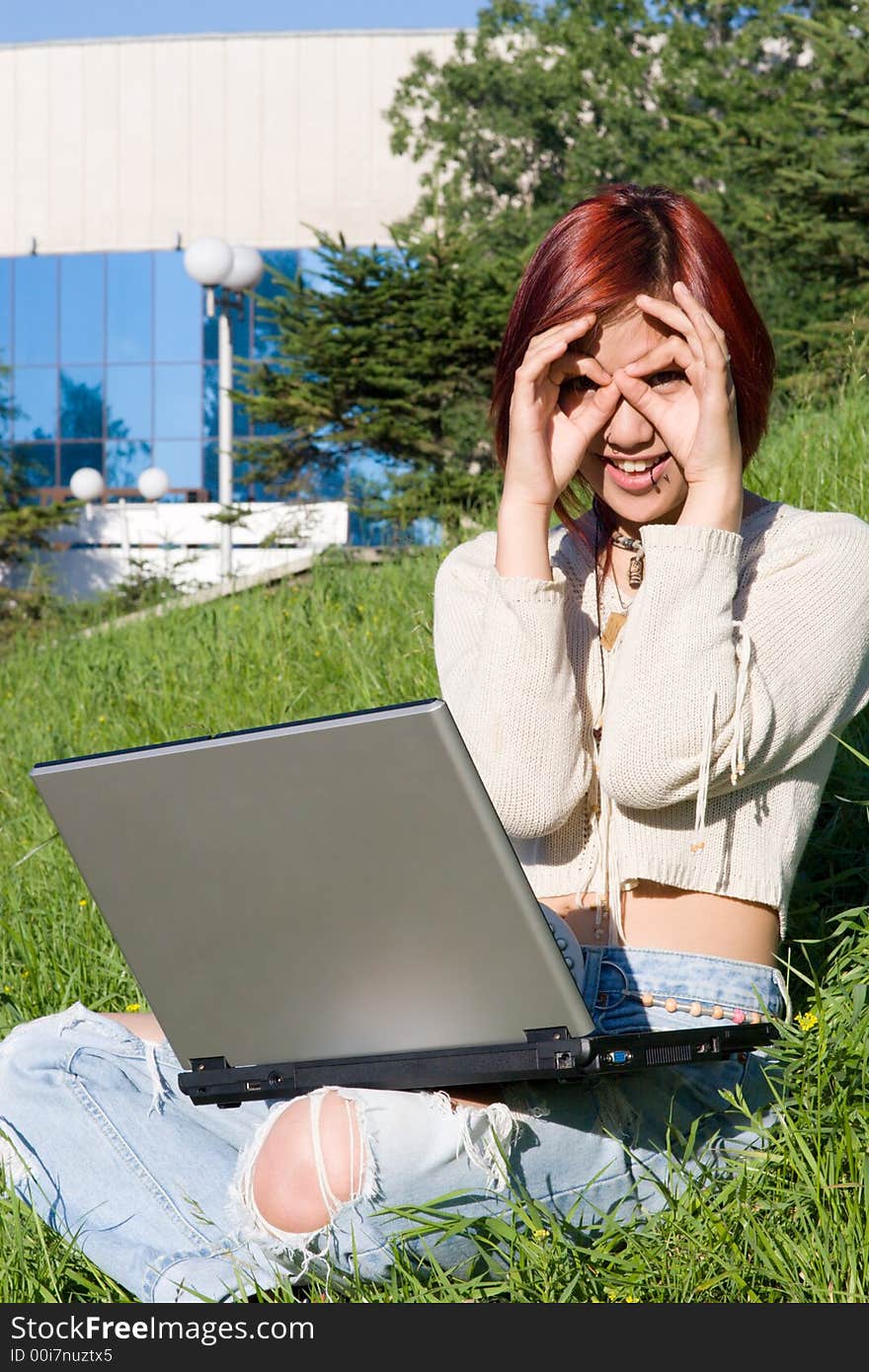 Teenager relaxing outdoors with notebook. Teenager relaxing outdoors with notebook