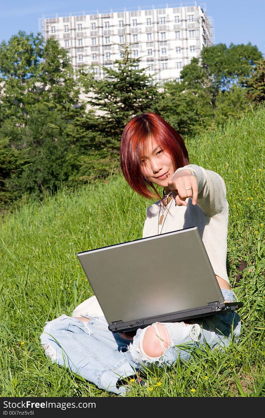 Teenager relaxing outdoors with notebook. Teenager relaxing outdoors with notebook