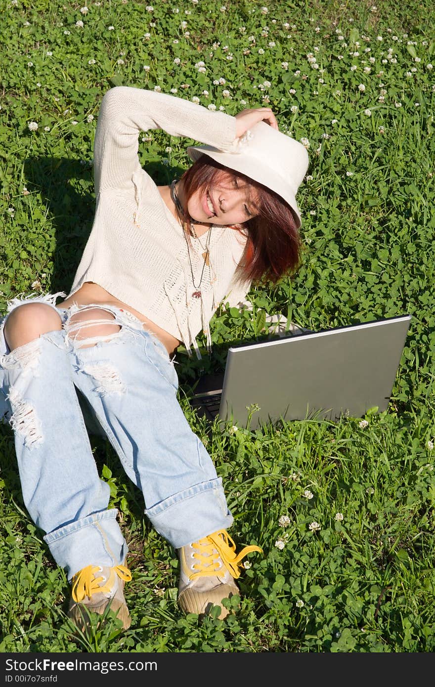 Teenager relaxing outdoors with notebook. Teenager relaxing outdoors with notebook