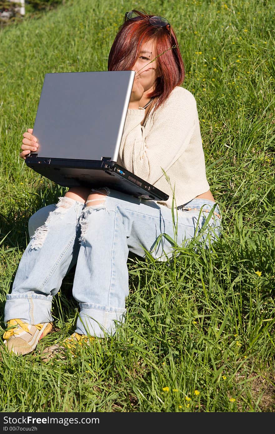 Teenager relaxing outdoors with notebook. Teenager relaxing outdoors with notebook