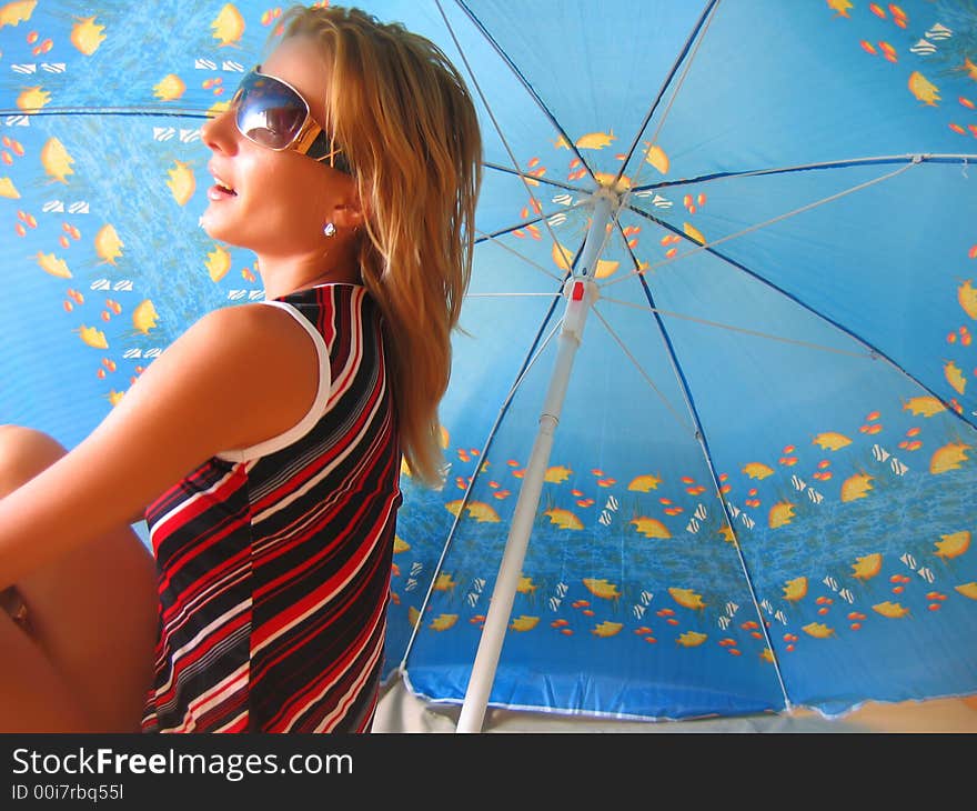 Girl Sitting Under An Umbrella