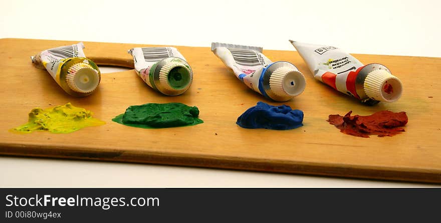 Isolated palette with tempera tubes - yellow, green, blue and red color. Isolated palette with tempera tubes - yellow, green, blue and red color.