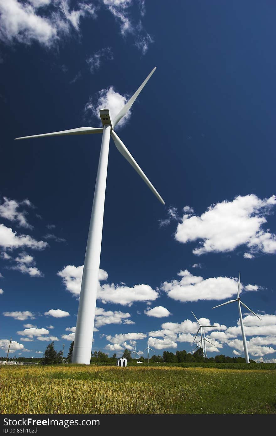 Windmills for generating electricity against a clear blue sky. Windmills for generating electricity against a clear blue sky.