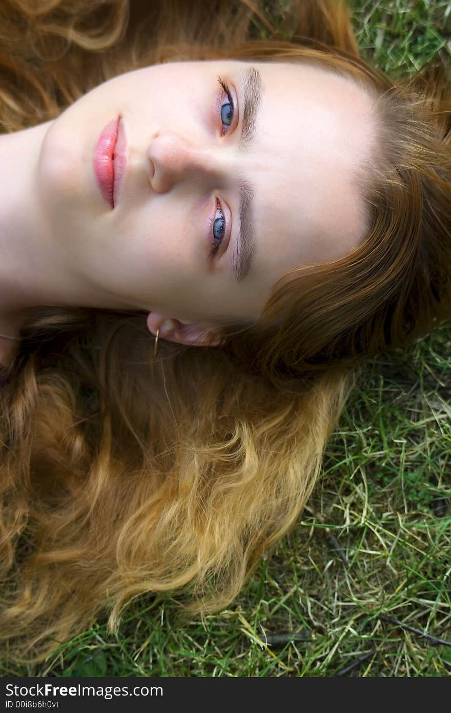 Portrait of the girl laying on a grass and looking in the sky. Portrait of the girl laying on a grass and looking in the sky