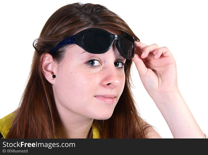 Attractive teen girl lifting sunglasses looking at camera and smiling. Attractive teen girl lifting sunglasses looking at camera and smiling