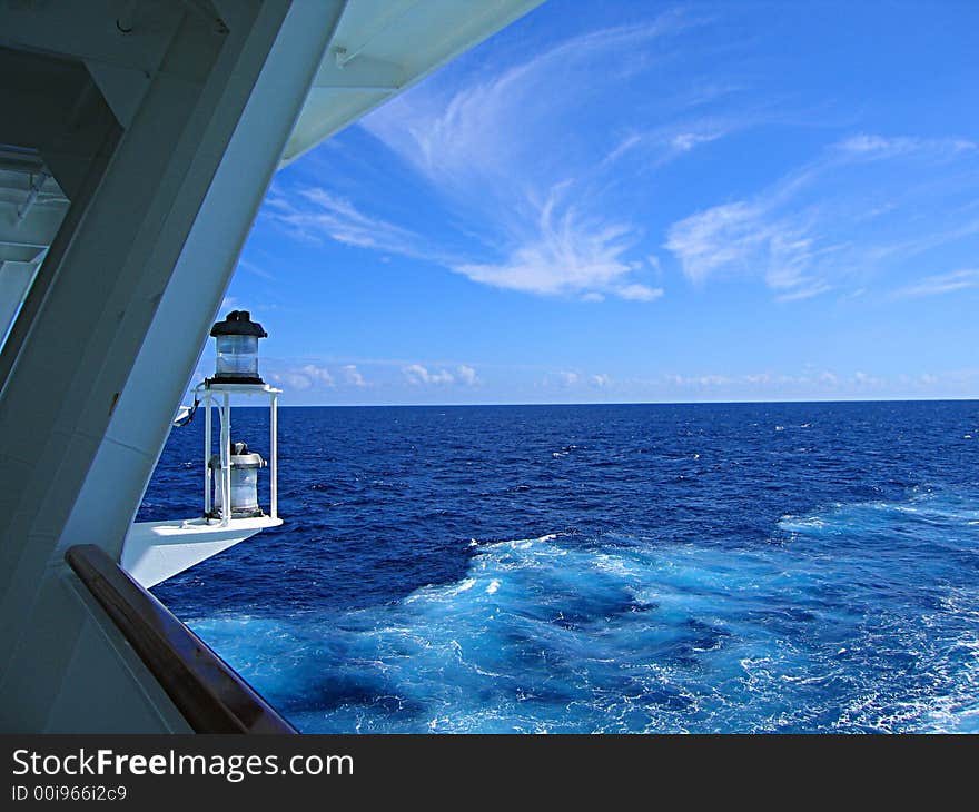 A view of a lantern and an open sea from  the deck