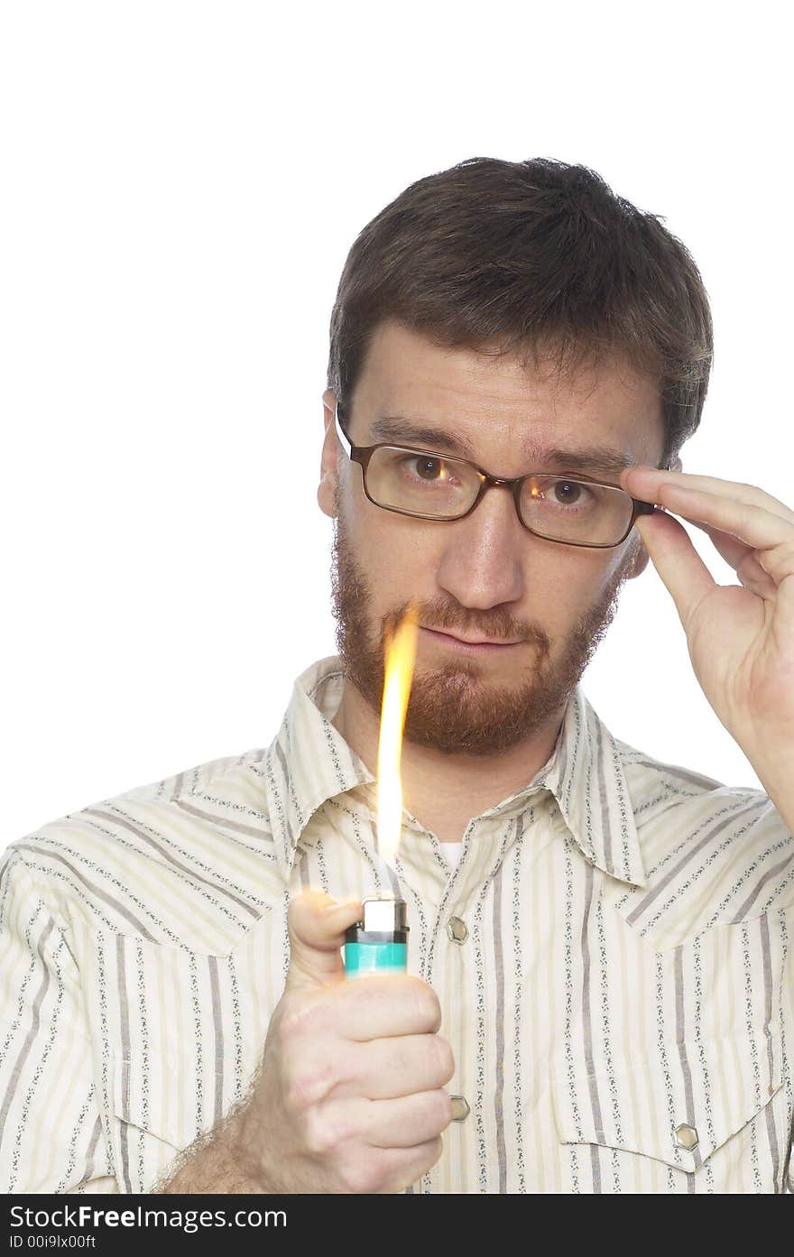 Man with beard turning on a lighter with a large flame against a white background. Man with beard turning on a lighter with a large flame against a white background.