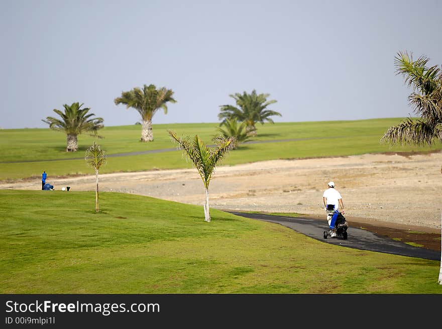 Golfer walking at path to next hole