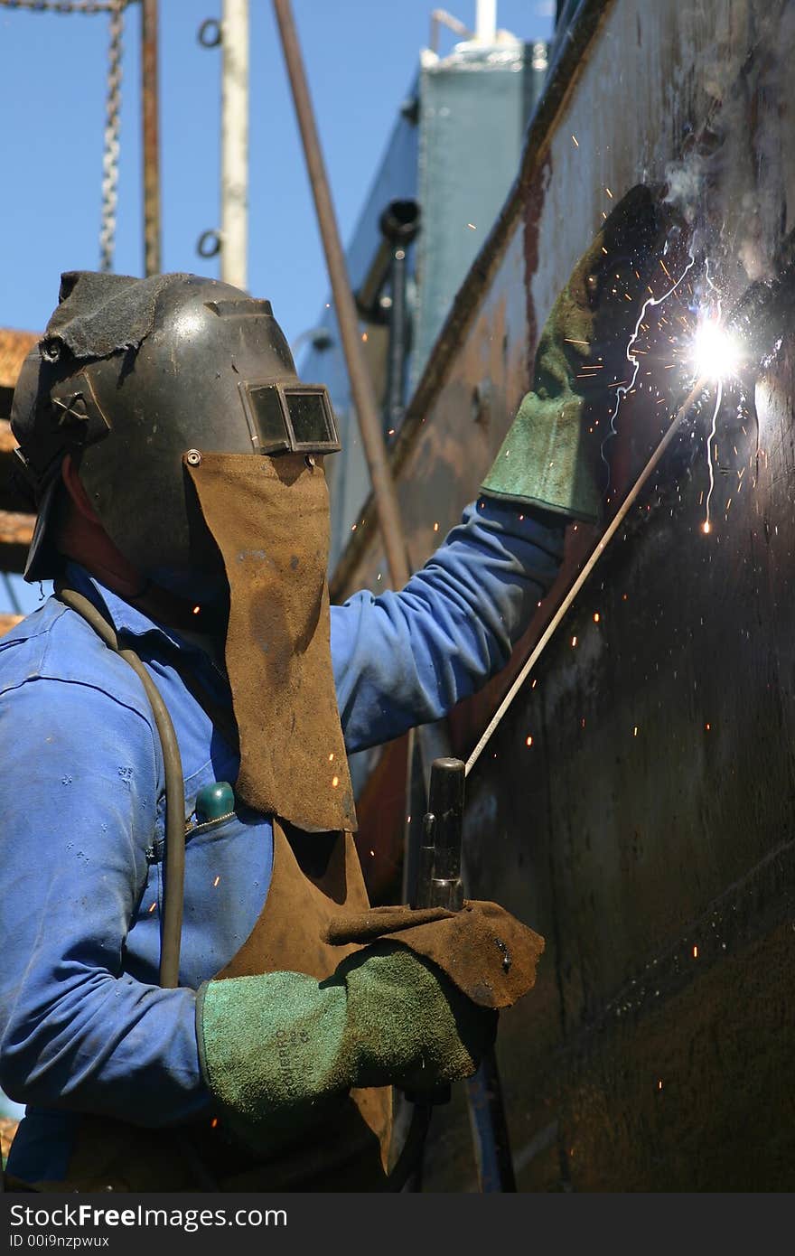 Metallurgist is welding with protection équipment