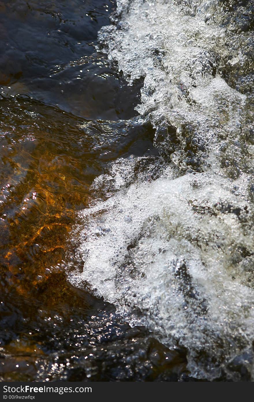 Little rapids and spray in a small river. Little rapids and spray in a small river