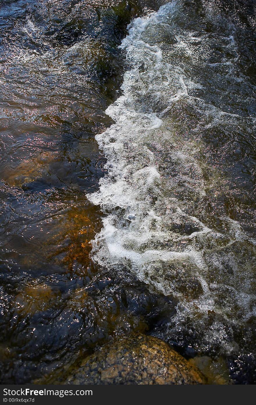 Small rapids and spray in a little river. Small rapids and spray in a little river