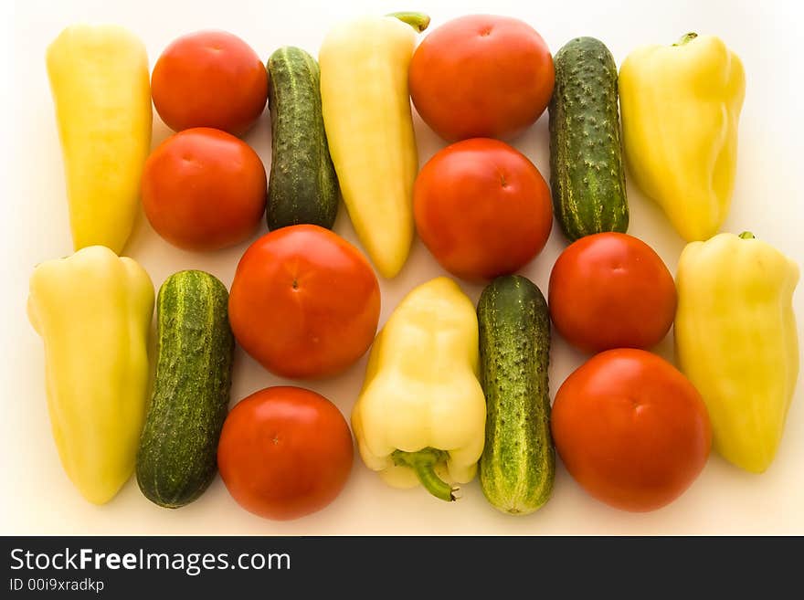 Tomatoes, peppers and cucumbers over white background. Tomatoes, peppers and cucumbers over white background