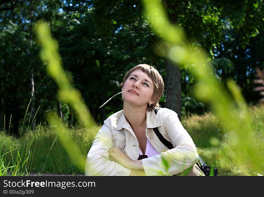 The girl on grassy plot in summer. The girl on grassy plot in summer