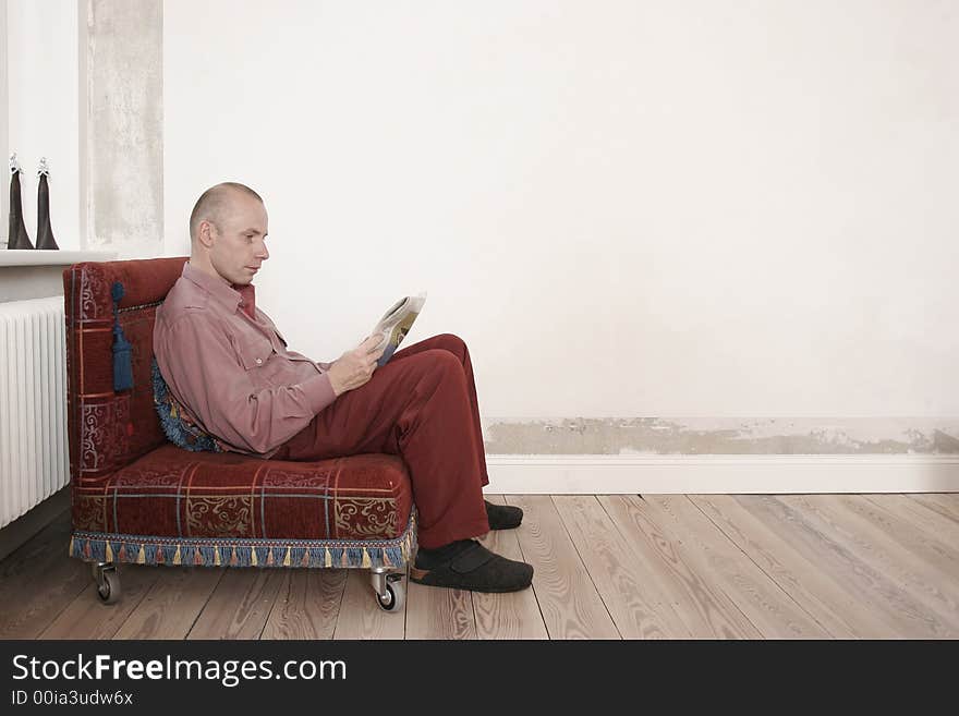 Man is reading a newspaper. Man is reading a newspaper