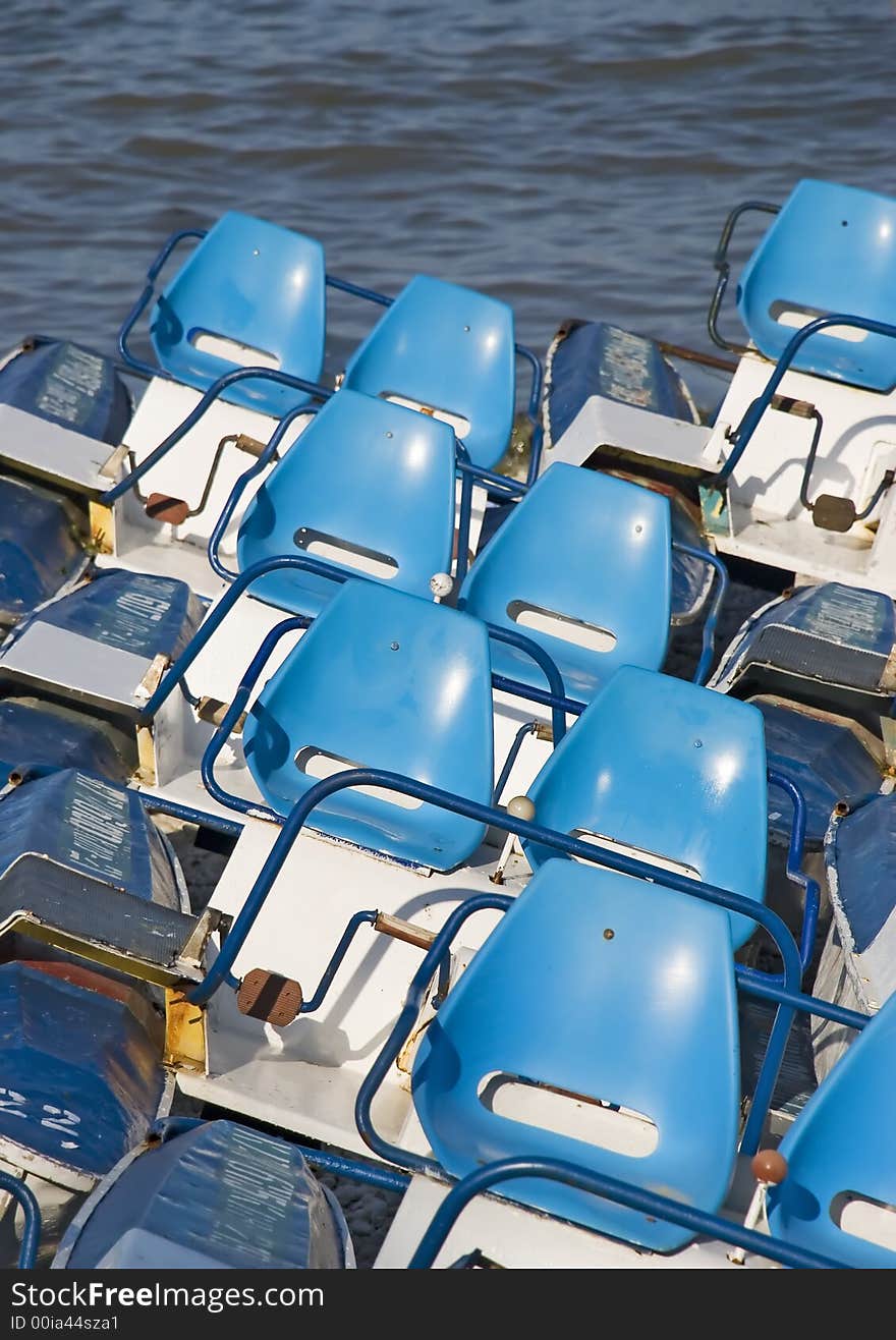 Catamarans combined on coast with brightly dark blue seats